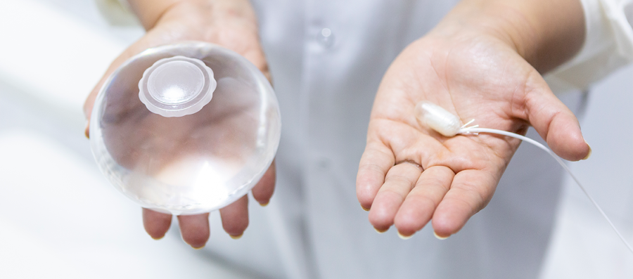 A Doctor holding the Allurion Gastric Balloon and Capsule in his hands