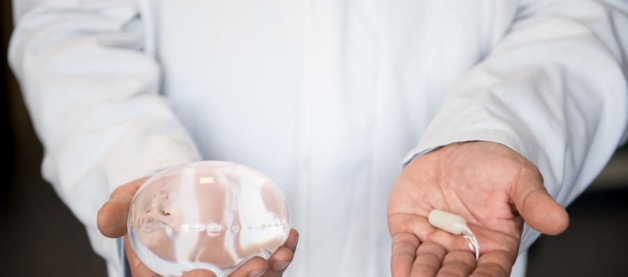 A Doctor holding the Allurion Gastric Balloon and Capsule in his hands